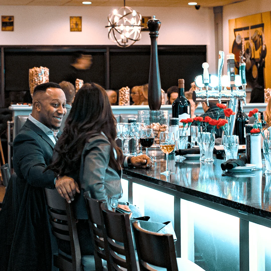 Guests seated at the bar inside Toscana Heritage